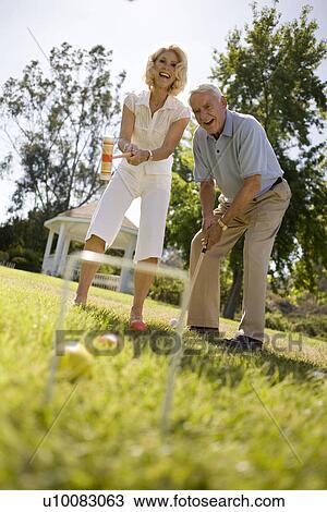 Stock Image - Mature couple in park. Fotosearch