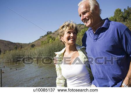mature couple walking by lake View Large Photo Image Stock Photo - mature couple walking by lake. Fotosearch