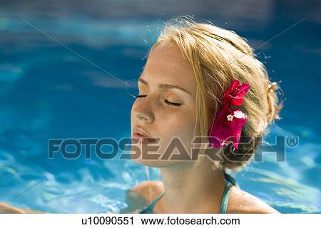 Stock Image - Woman by pool. Fotosearch