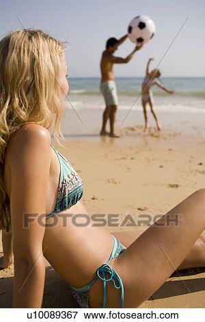 Stock Photo - Family on beach playing together. Fotosearch