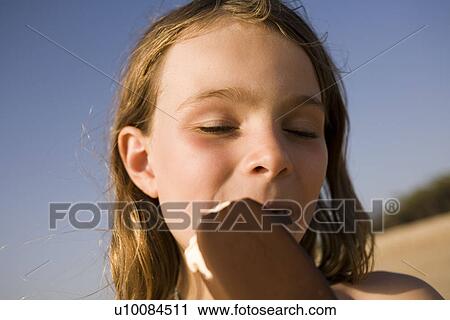 Girl eating ice cream View Large Photo Image Stock Image - Girl eating ice cream. Fotosearch