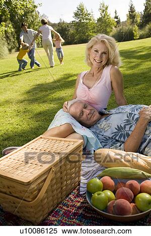 Grandparents and family in park View Large Photo Image Stock Photography - Grandparents and family in park. Fotosearch