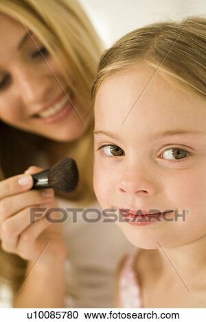 Stock Image - Mother and daughter with makeup. Fotosearch
