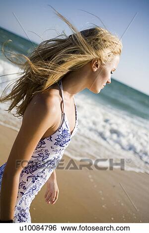 Stock Photograph - One women on beach. Fotosearch