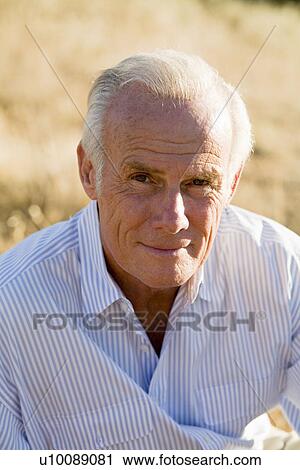 Stock Image - Senior man outdoors looking at camera. Fotosearch
