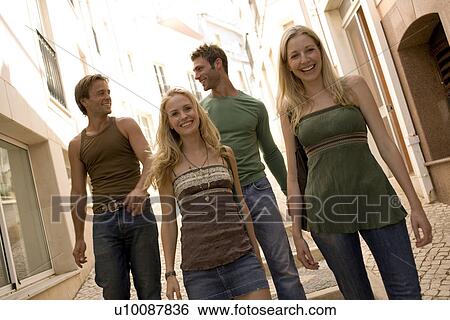 Stock Photograph - Two couples walking in town. Fotosearch