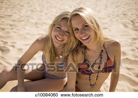 Stock Image - Two women on beach. Fotosearch
