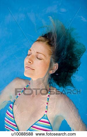 Woman swimming in pool View Large Photo Image Stock Photo - Woman swimming in pool. Fotosearch