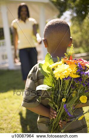 Young boy and mother with flowers View Large Photo Image Picture - Young boy and mother with flowers. Fotosearch