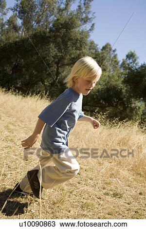 Stock Image - Young boy in park. Fotosearch