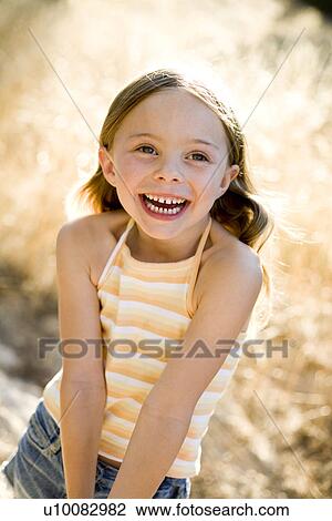 Stock Image - Young girl in park. Fotosearch