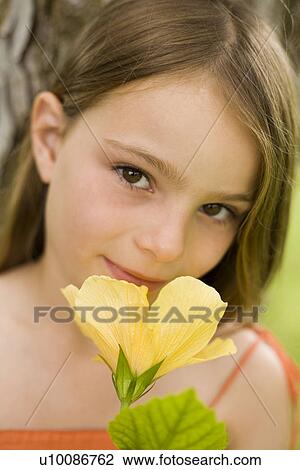 Stock Image - Young girl with flower. Fotosearch