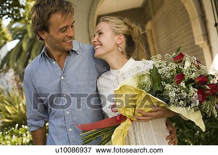 Stock Photo - Couple with flowers. Fotosearch