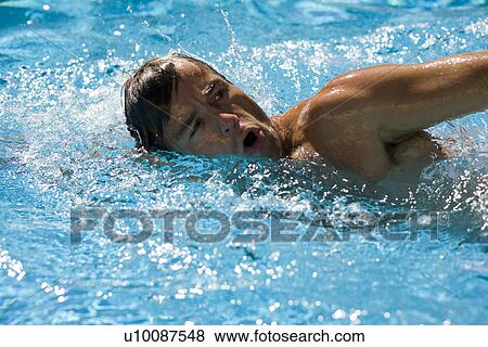 Stock Photo - Man swimming in pool. Fotosearch