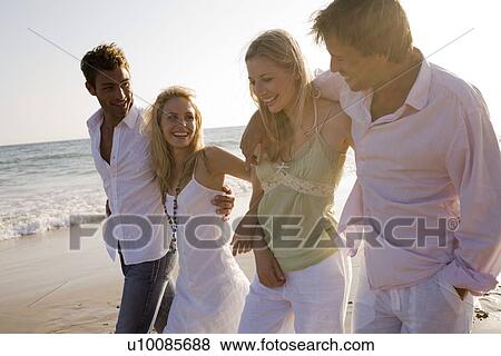 Two couples on beach View Large Photo Image Stock Photo - Two couples on beach. Fotosearch