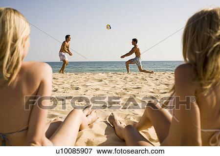Two couples playing on beach View Large Photo Image Stock Photo - Two couples playing on beach. Fotosearch