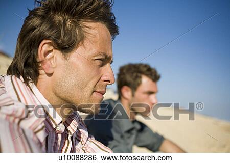 Stock Photograph - Two men on beach. Fotosearch