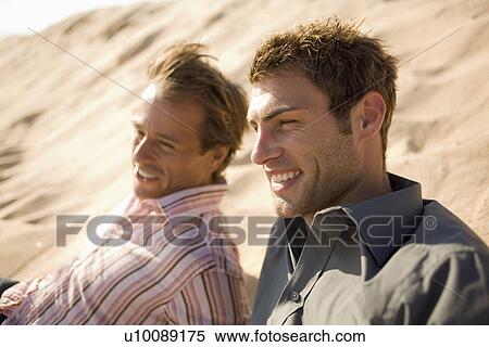 Stock Photography - Two men on beach. Fotosearch