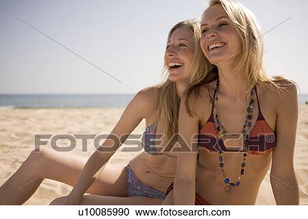 Stock Image - Two women on beach. Fotosearch