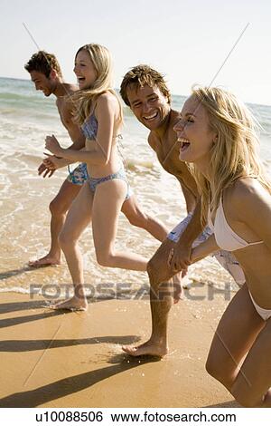 Two young couples on beach View Large Photo Image Stock Photograph - Two young couples on beach. Fotosearch