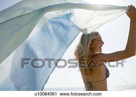 Woman on beach with shawl View Large Photo Image Stock Image - Woman on beach with shawl. Fotosearch