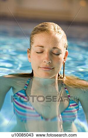 Woman swimming in pool View Large Photo Image Stock Image - Woman swimming in pool. Fotosearch