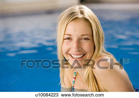 Stock Image - Young woman in swimming pool. Fotosearch