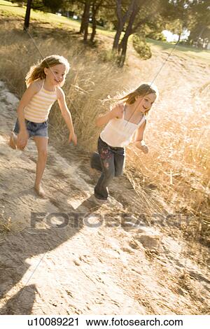 Stock Image - Children running in park. Fotosearch