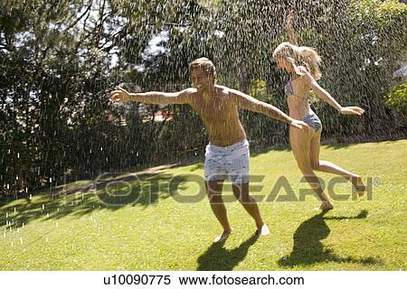 Couple at home playing in yard View Large Photo Image Stock Photography - Couple at home playing in yard. Fotosearch
