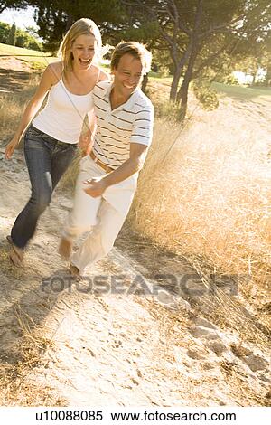 Couple running on path View Large Photo Image Stock Photography - Couple running on path. Fotosearch