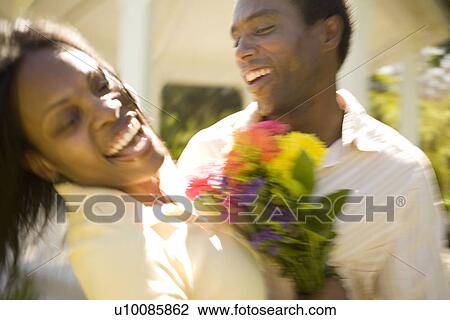 Stock Image - Couple with flowers. Fotosearch
