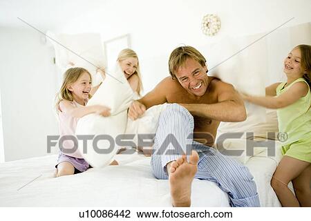 Family at home having pillow fight View Large Photo Image Stock Image - Family at home having pillow fight. Fotosearch