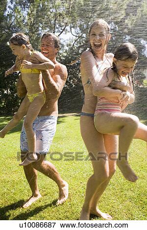 Family at home playing in garden View Large Photo Image Stock Photo - Family at home playing in garden. Fotosearch