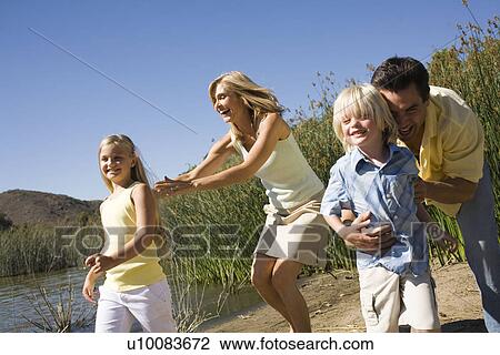 Stock Image - Family by lake. Fotosearch