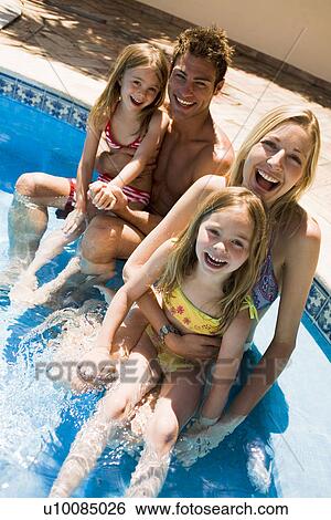 Stock Photograph - Family by pool. Fotosearch