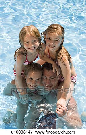 Family playing in pool View Large Photo Image Stock Photo - Family playing in pool. Fotosearch