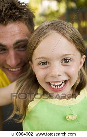 Stock Image - Father and daughter in park. Fotosearch