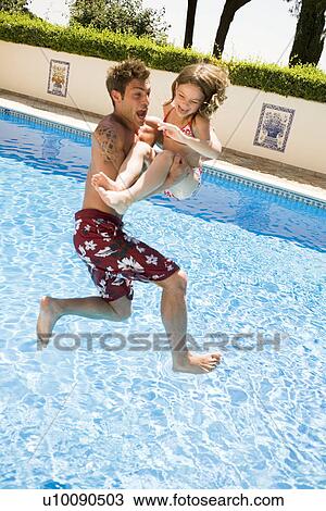 Stock Image - Father and daughter in pool. Fotosearch