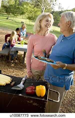 Grandparents and family in park with barbeque View Large Photo Image Stock Image - Grandparents and family in park with barbeque. Fotosearch