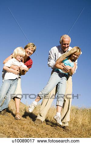 Grandparents and Grandchildren playing in park View Large Photo Image Stock Photo - Grandparents and Grandchildren playing in park. Fotosearch