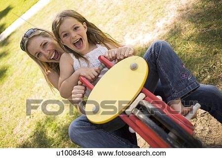 Stock Photo - Mother and daughter in park. Fotosearch