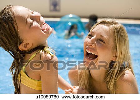 Mother and daughter playing in pool View Large Photo Image Stock Image - Mother and daughter playing in pool. Fotosearch