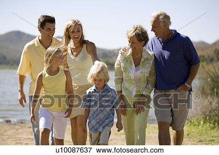 Three generations of family walking by lake View Large Photo Image Stock Photo - Three generations of family walking by lake. Fotosearch