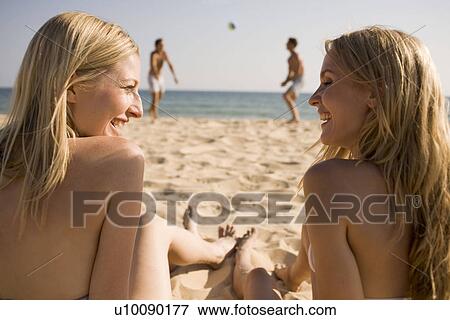 Stock Photo - Two couples playing on beach. Fotosearch