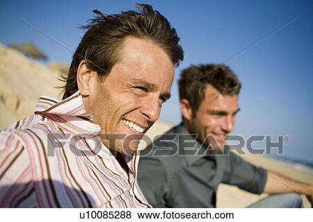 Stock Photo - Two men on beach. Fotosearch