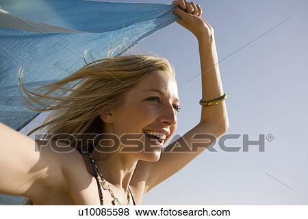 Stock Photo - Woman on beach with shawl. Fotosearch