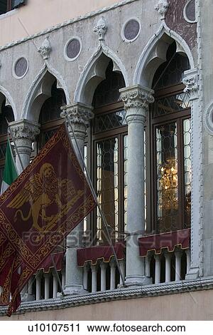 Arched window details with ornamented columns on Venician Pallazzo. Winged lion flag in foreground and venetian glass chandelier though leaded window. View Large Photo Image Stock Image - Arched window details with ornamented columns on Venician Pallazzo. Winged lion flag in foreground and venetian glass chandelier though leaded window.. Fotosearch