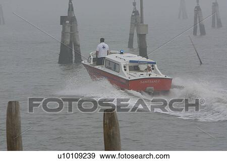 Stock Photo - Ambulance boat in morning mist, Venezia lagoon. Fotosearch