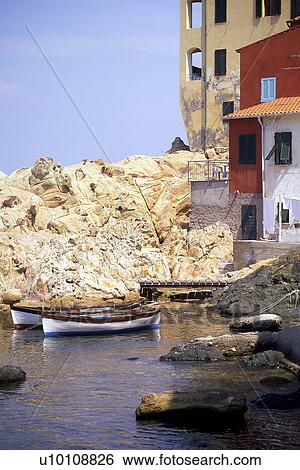 Beachside housing, red yellow white with boats in water and rocky outcrop Elba Italy View Large Photo Image Stock Photograph - Beachside housing, red yellow white with boats in water and rocky outcrop Elba Italy. Fotosearch