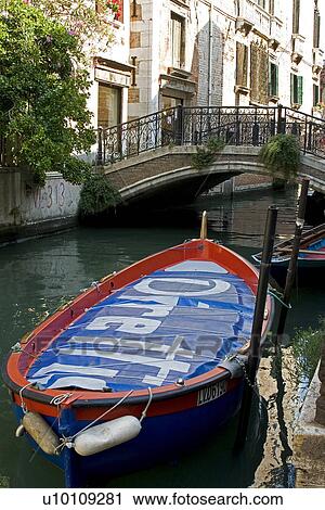 Building reflected in quite canal - boat moored in foreground. Bridge over canal. View Large Photo Image Stock Image - Building reflected in quite canal - boat moored in foreground. Bridge over canal.. Fotosearch